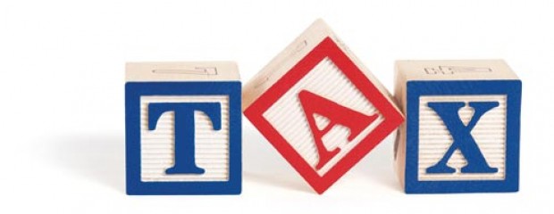 Three building blocks with letter TAX on